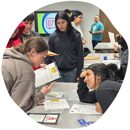 Students at a table discussing their project
