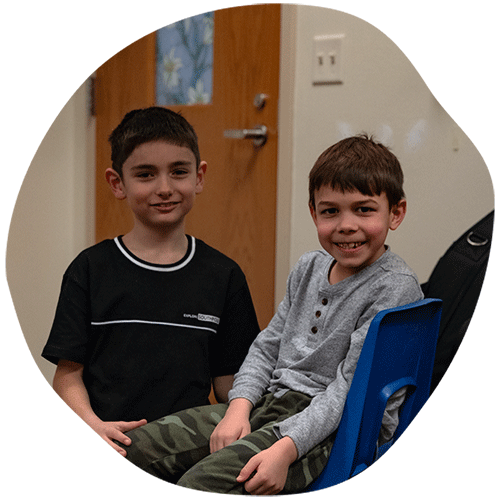 Two boys next to each other smiling